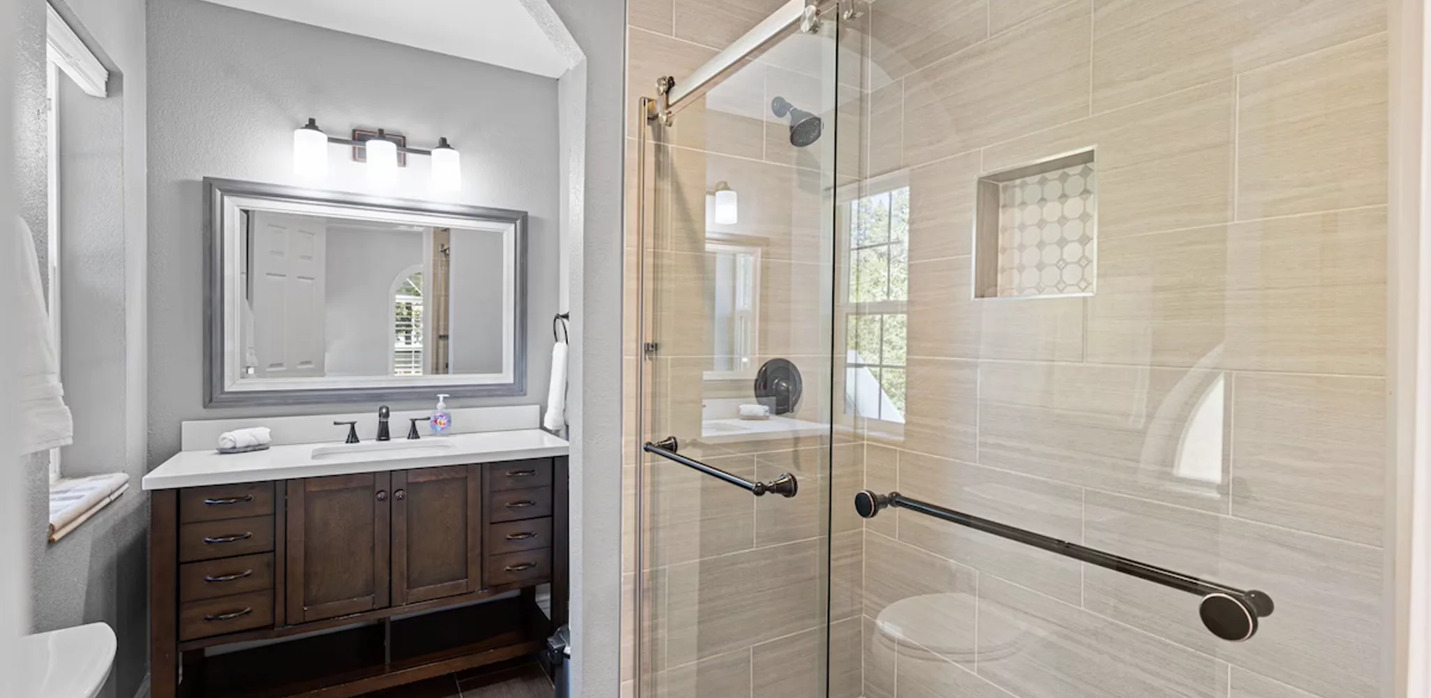 A finished master bathroom with a walk-in shower and a double vanity