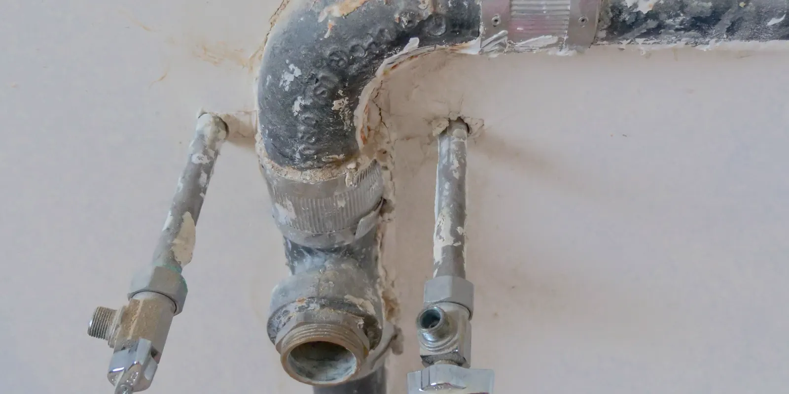 Exposed water pipes on a bathroom wall before the tile goes on, bathroom remodel