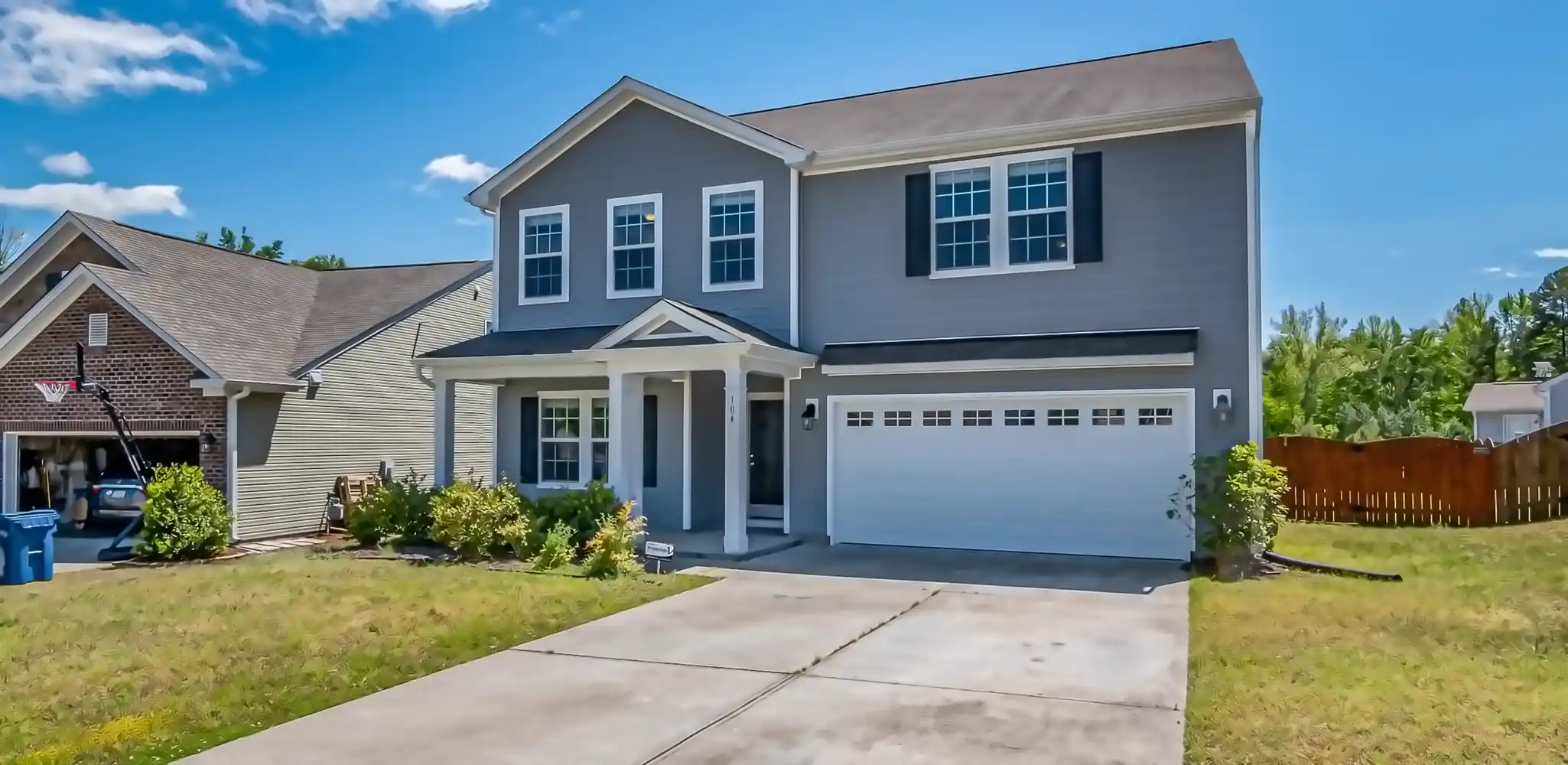 A two story house with an attached garage and driveway, driveways