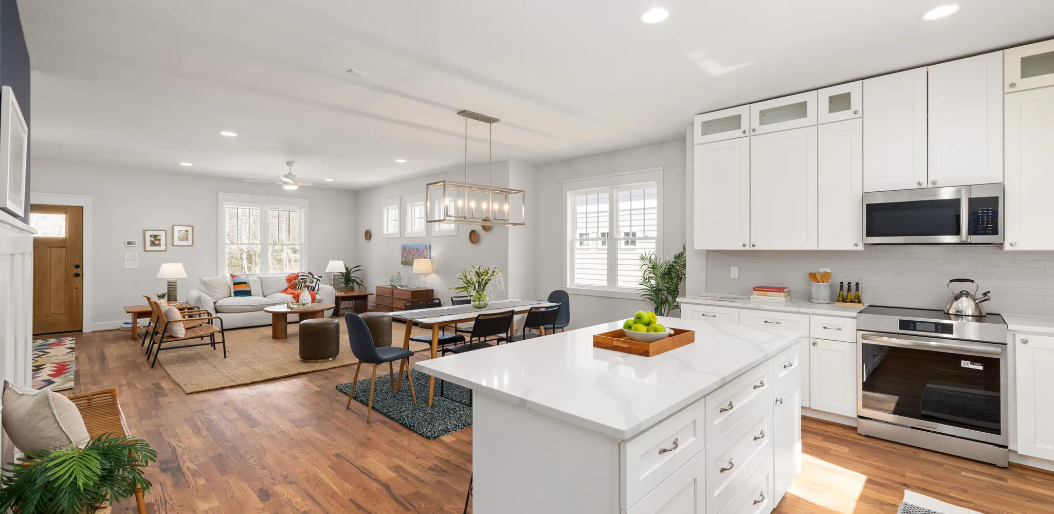 A white kitchen island facing the dining table and living room, home remodeling