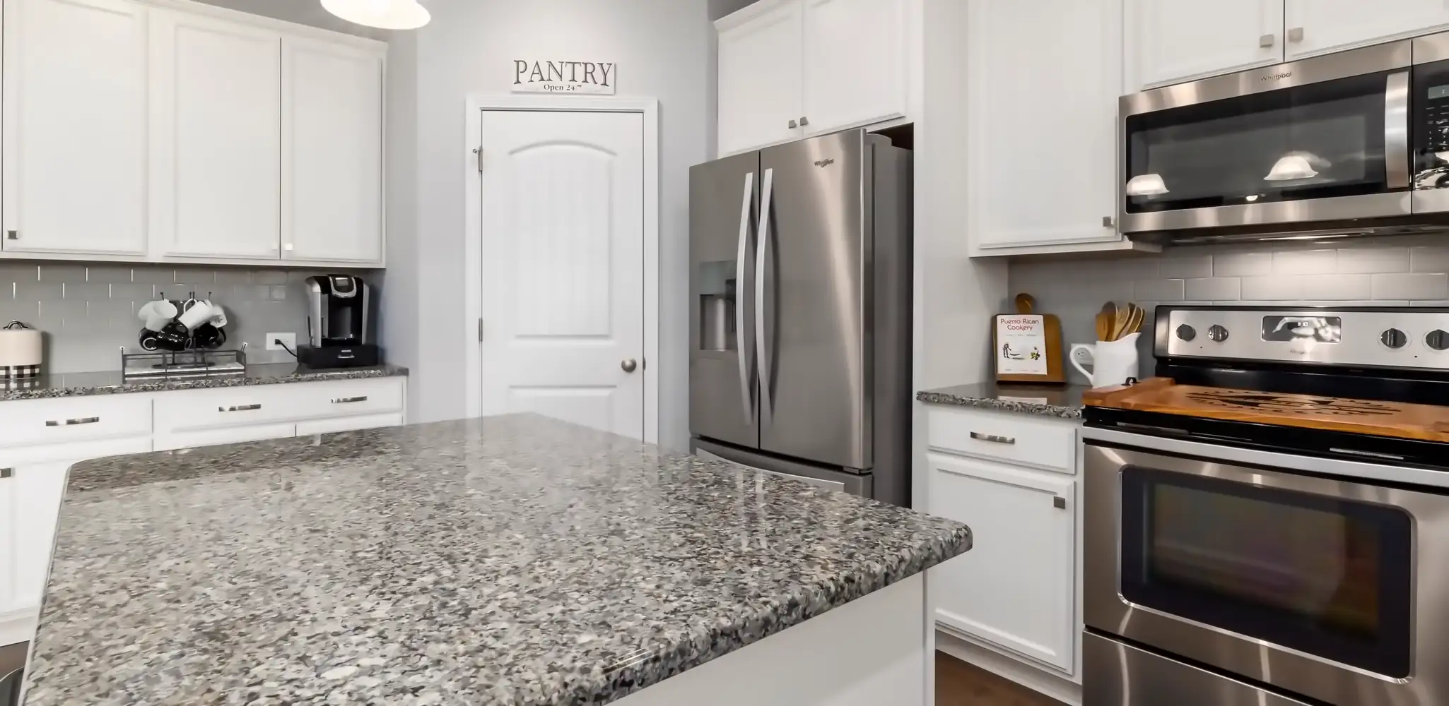 A kitchen with granite counters and stainless steel appliances, kitchen remodeling