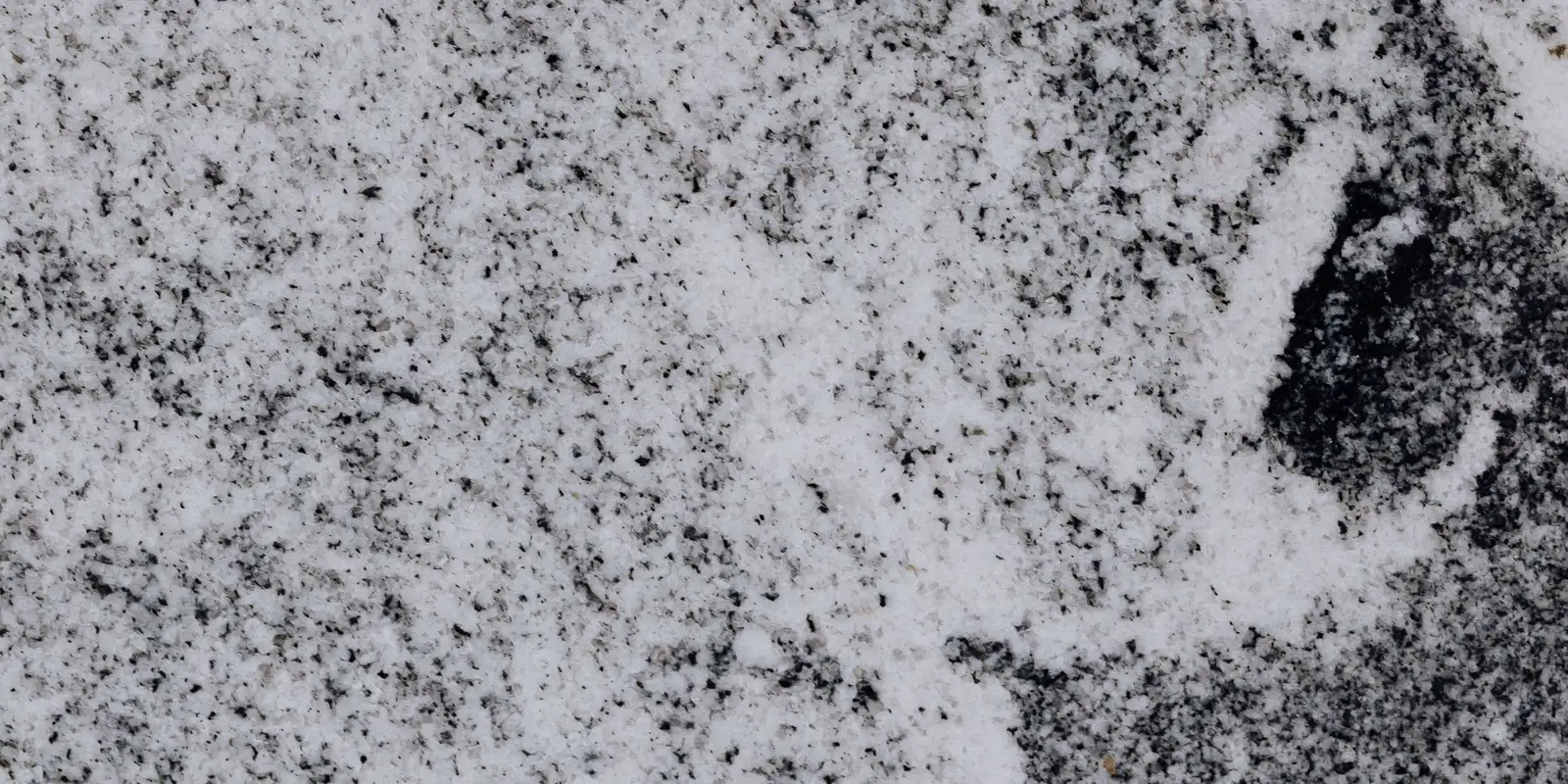 Close up of a white stone countertop surface with soft veins, kitchen countertop installation