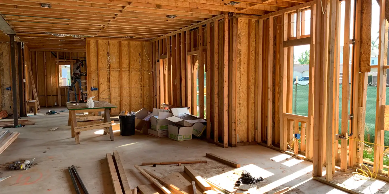 A sunlit interior with the wood framing exposed before the walls close, kitchen remodel cost