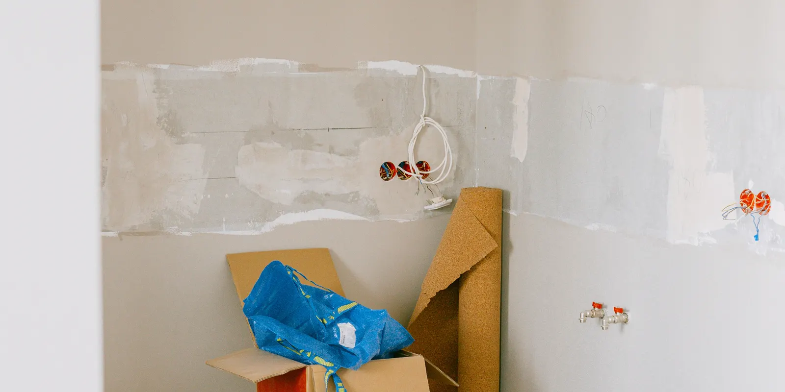 A room in the middle of a home renovation with tools and bare walls, kitchen remodel cost