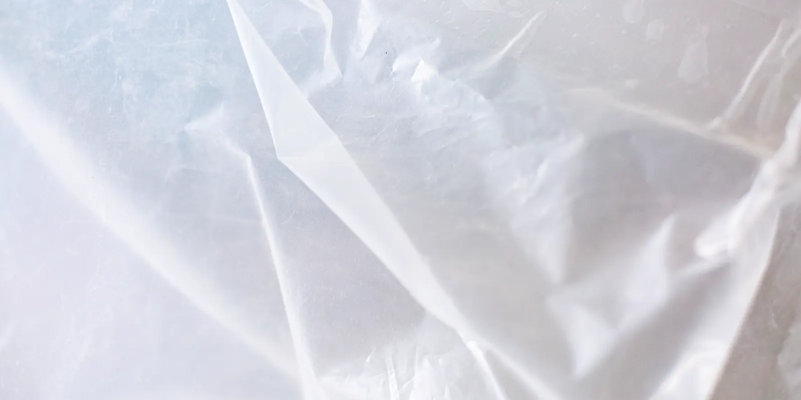 Close up of transparent plastic sheeting laid as a moisture barrier, luxury vinyl plank flooring