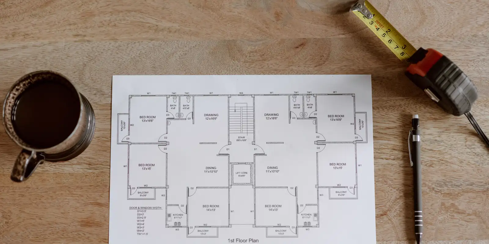 A floor plan on a table with a tape measure and a pencil, master bathroom remodel