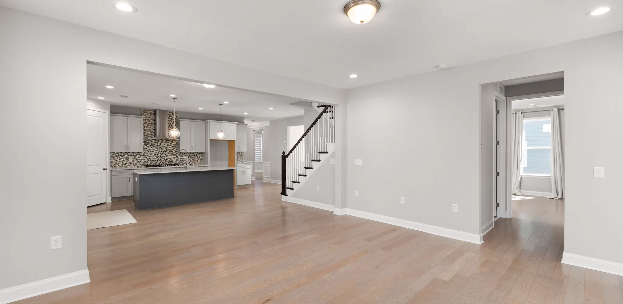 An open living room with light wood plank flooring, flooring