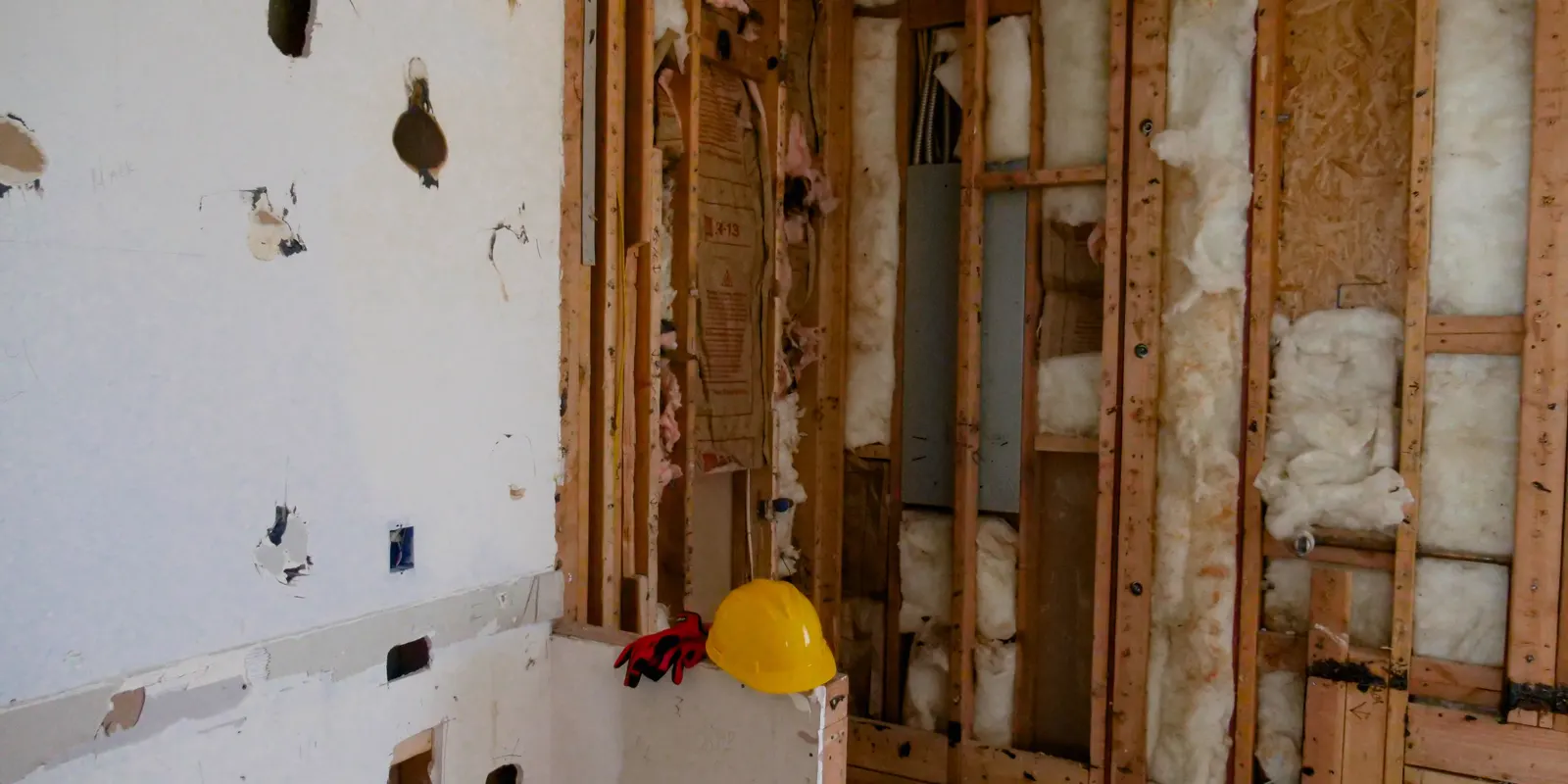 A room opened to the studs during a remodel, tub to shower conversion